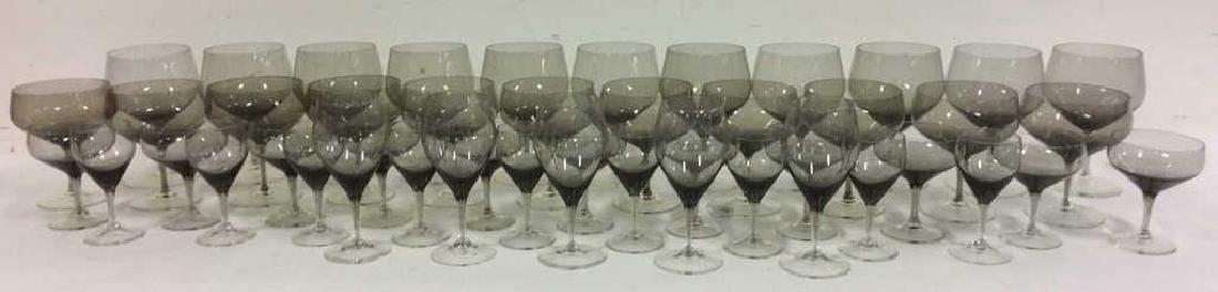 Lot 46 Assorted Cocktail & Wine Glasses: Includes 11 tall wine glasses, 10 large cocktail glasses, 11 small cocktail glasses, 9 sampler wine glasses, & 5 mid sized wine glasses. Largest glass measures approx 6 inches tall 3.5 inches diameter