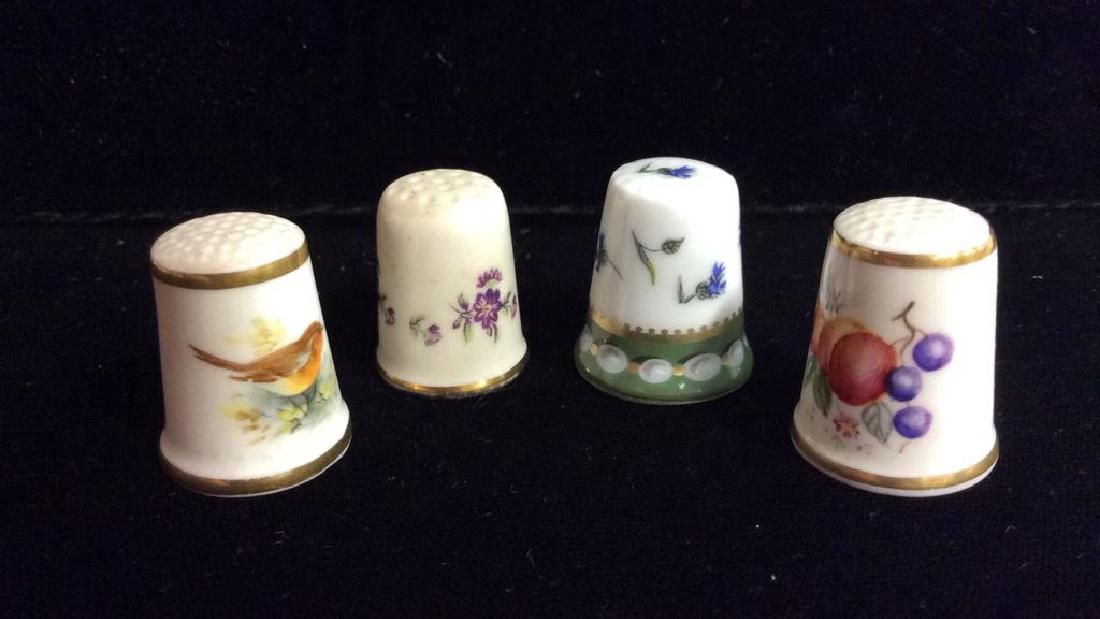 Lot 4 Vintage Fine Bone China Sewing Thimbles: Lot 4 Vintage Fine Bone China Sewing Thimbles. Four white toned sewing thimbles decorated with floral illustrative detail and geometric detail, one thimble decorated with small bird illustrative detai