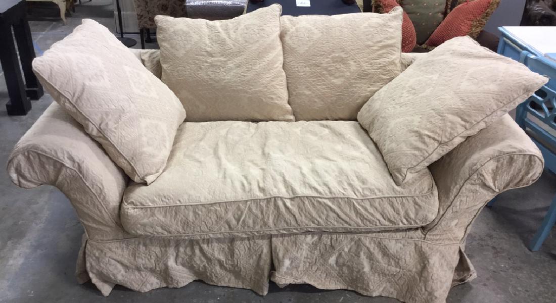 DOMAIN Slipcovered Loveseat: Loveseat with 4 loose pillows. Covered with beige slipcover over white fabric. Measures approx 28 inches H x 72 inches W x 39 inches D. A few paint marks on slipcover, otherwise no condition issues no