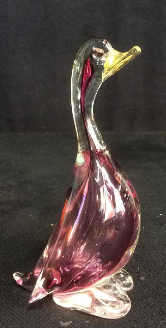 Fuchsia and Clear Glass Duck Sculpture: fuchsia and clear glass body with gold tone metallic filled beak. Possibly hand blown, possibly Italian art glass, Measures approx 5 1/2 inches tall by 3 inches wide.