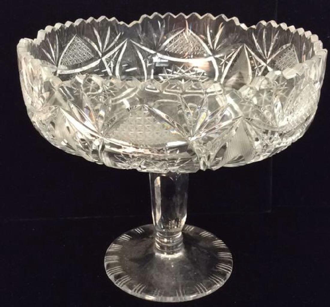 Crystal Cut Pedestaled Vase: Crystal Cut Pedestaled Vase. Footed Bowl, Centerpiece Bowl, Serveware, Fruit Bowl, Contains toothed rim. Contains intricate geometric detail. Measures approx 7.5 inches tall 8 inches diameter. Crystal