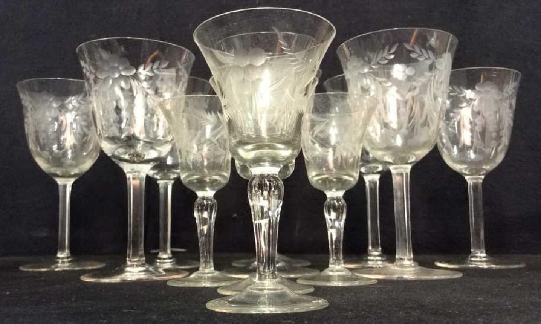 Lot 12 Assorted Crystal Cocktail & Wine Glasses: Contains 1 tall cocktail glass 7 wine glasses and 4 small tasting glasses. All contain frosted floral and vine detail. Each etched, Wine glasses are crystal sampler glass and cocktail glass are glass.