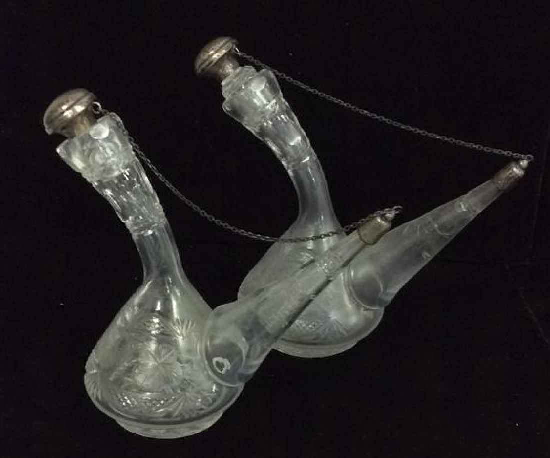 Pair Cut Glass Etched Glass Vinegar and Oil: Pair Cut Glass Etched Glass Vinegar and Oil Pitchers. Cruets, Flasks with silver toned lids,Geometric cut glass with etched floral motif, dark silver toned toppers. Pieces measure approx 6 in tall by