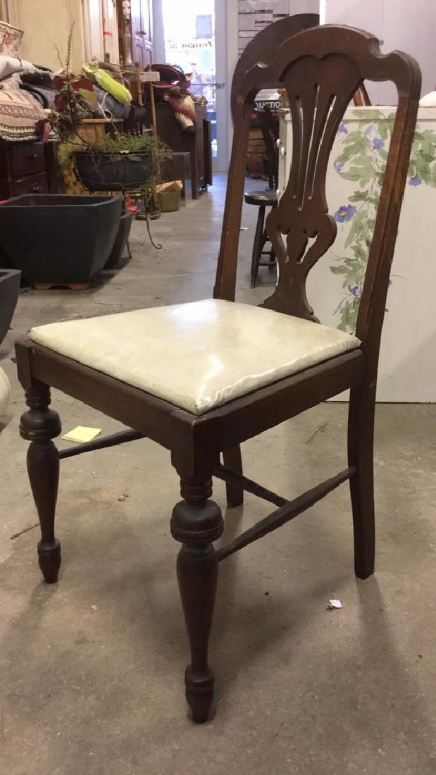 Vintage Carved Wooden Chair W Cushion: Vintage possibly antique Carved Wooden Chair With cream toned removable Cushion. back rest has carved vase shaped detail. Measures approx 35 inches tall, 17 inches wide 18 inches deep. Chippendale Sty