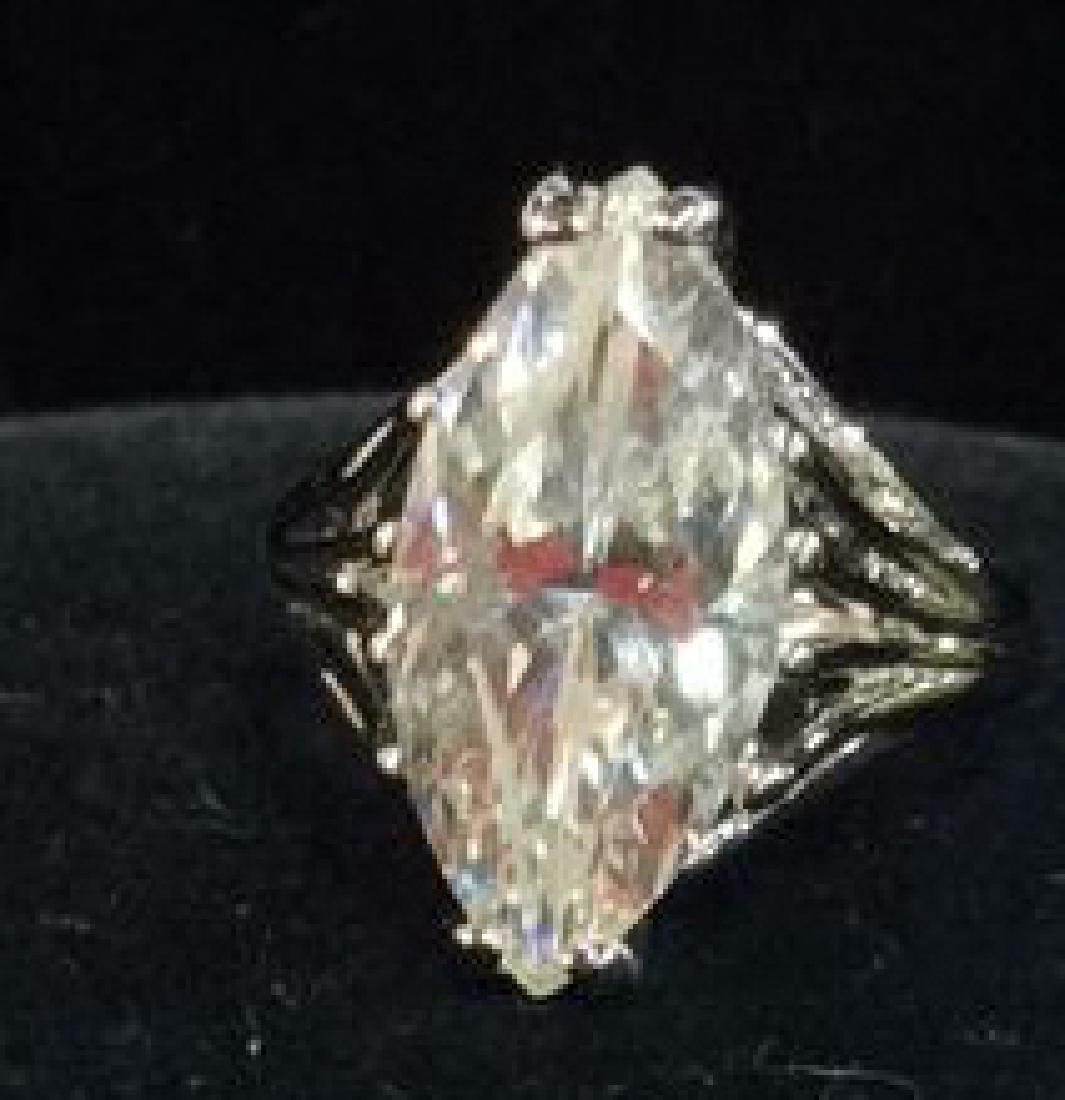 18K White Gold Plate Ring Estate Jewelry: 18K White Gold Plate Ring. Non diamond estate jewelry. Marked as 18k HGE. Non diamond center stone, has not been professionally inspected, possible colorless tourmaline. Ring is approximately a size 7