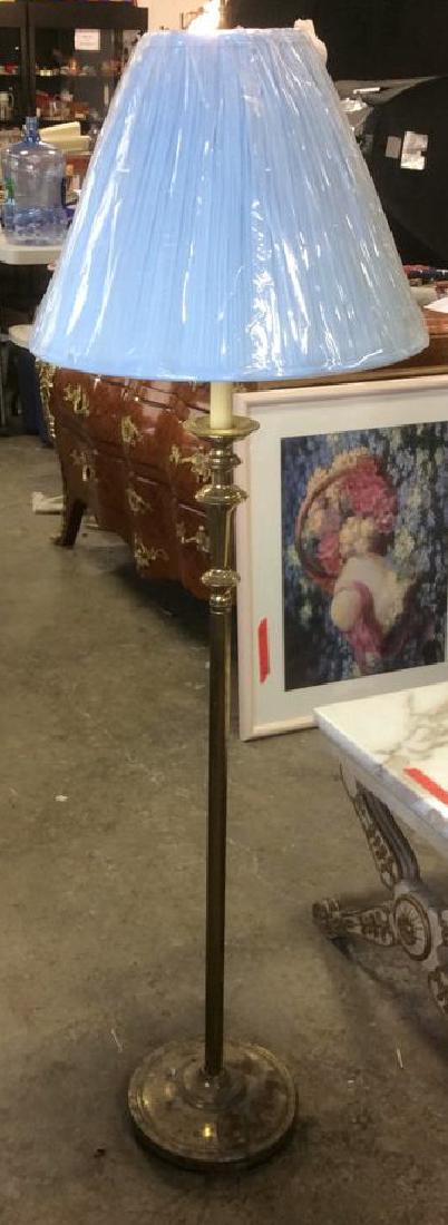 Gold Toned Brass Lamp: Gold Toned Brass Lamp. Comes with light blue toned shade and gold toned finial. Lamp has not been tested. Measures approx 56 inches tall 9 inches diameter at base.