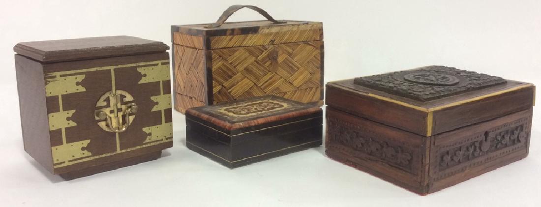 Lot 4 Wooden Trinket Boxes: 4 wooden trinket boxes. 1 appears to carved, 1 is enameled with maroon, tan and white toned detail, 1 is brown and gold toned with coasters inside, one contains handle on top. All boxes have some chip