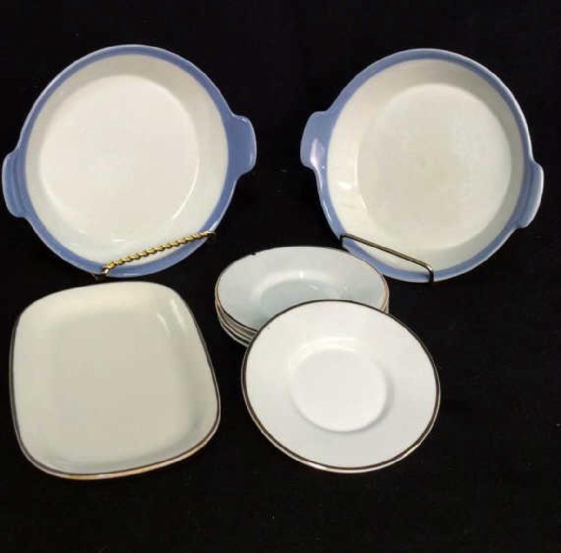 Lot 7 Porcelain Dishes W Saucers: Lot 7 Porcelain Dishes W Saucers. Porcelain teacup saucers with gold toned metallic trim, marked on back as TIFFANY&Co. Butter dish brown toned trim marked on bottom as MIKASA, matching handled dishes