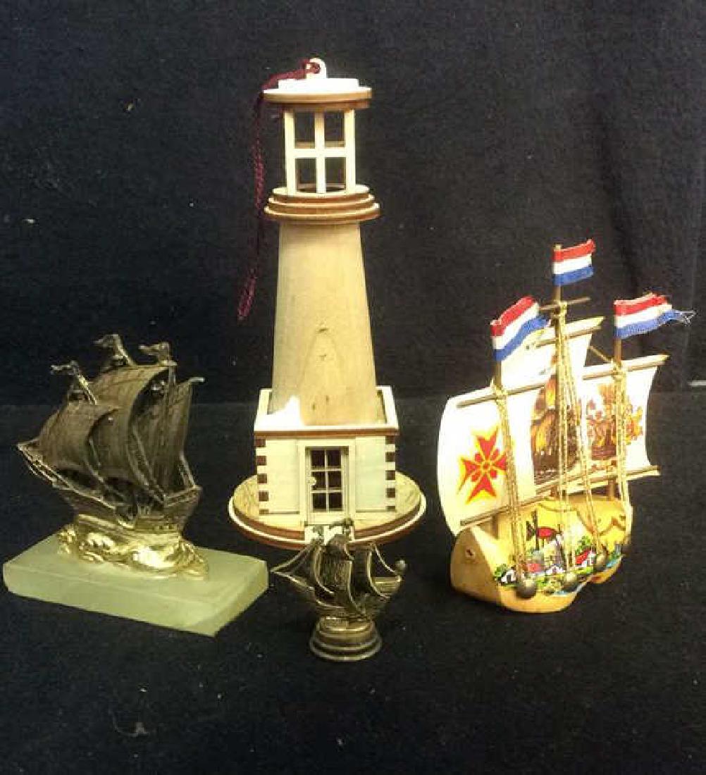 Lot 4 Nautical Accessories: Comes with miniature wooden lighthouse, 1 gold toned ship with base, 1 gold toned ship & 1 painted wooden ship with Netherlands flag. Lighthouse measures approx 6 inches tall 3 inches diameter at base