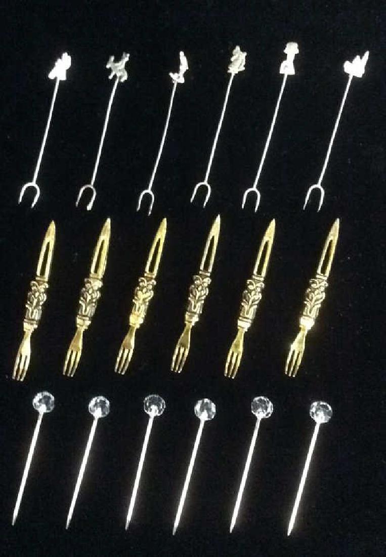 Lot 18 Hors Devours Forks: 18 Hors Devours Forks. Comes with 6 gold toned 3 pronged forks, 6 silver toned 2 pronged forks with various shapes, and 6 silver toned 1 prong forks with glass orb shaped top. Wan measures approx 3 in