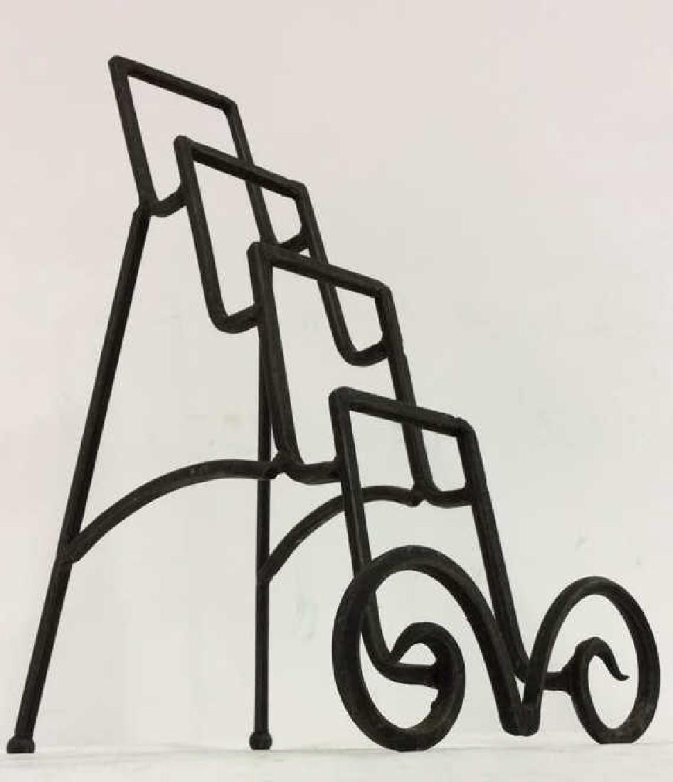 Black Toned Metal Book Holder: Black Toned Metal Book Holder. Contains 3 book spaces. Measures approx 12 inches tall 9 inches deep 6 inches wide.