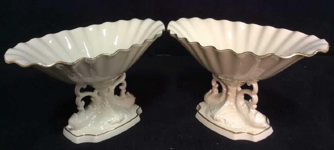 Pair LENOX Porcelain Footed Pedestal Serveware: Includes 2 Pedestal Serving pieces, table top , marked LENOX on underside. Dishes have cream tone with gold toned accents. Both contain intricately detailed pedestals. with fish forms, A dishes have f