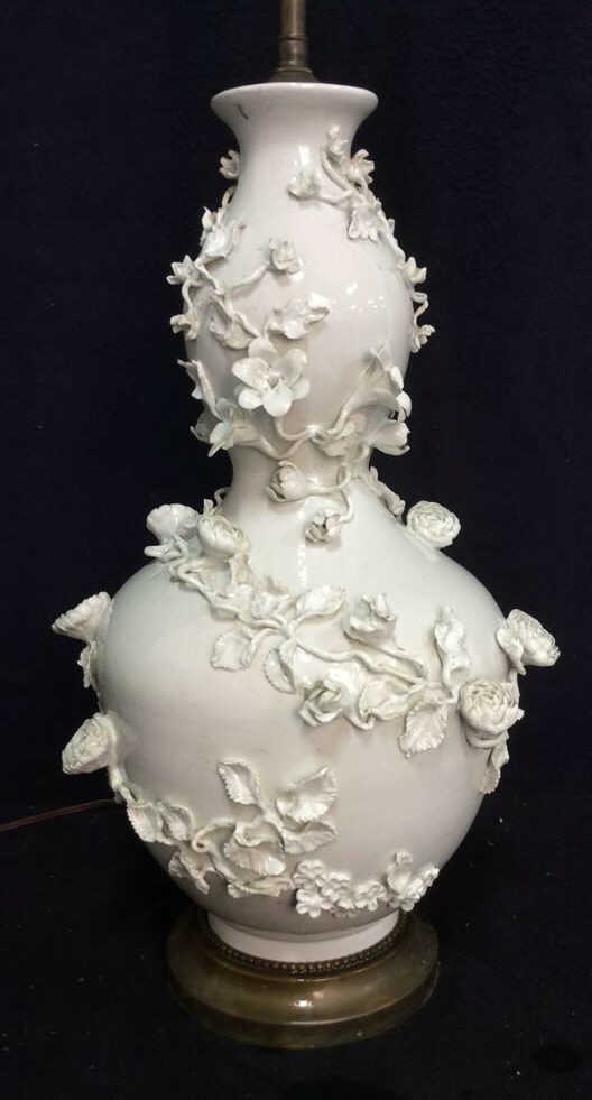 Sculpted Floral Asian Gourd Form Porcelain Lamp: VIntage possibly antique gourd form lamp, with applied flral wrap design, garden design, Sculpted Floral Porcelain Lamp. White toned porcelain vase with oblong shape and fluted style body. Decorated w