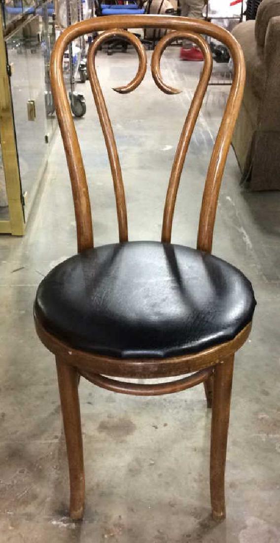 Wooden Bentwood Chair With Black Toned Cushion: Vintage Possibly Bentwood cushioned chair. Chair is wooden and light brown toned. Cushion appears to be black toned leather. Left side of backrests needs tightening. Ice Cream Parlor Style, Side Chair