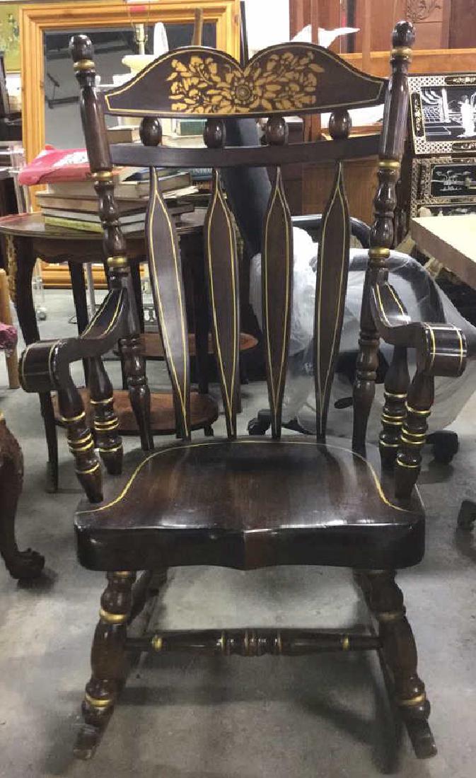 Carved Wooden Rocking Chair W Gold Toned Detail: Vintage Carved Brown toned wooden rocking chair, possibly vintage. Contains gold toned accents and floral detailed. Painting detail in Pennsylvania Dutch Style, Contains some minor cracks & chips. Mea