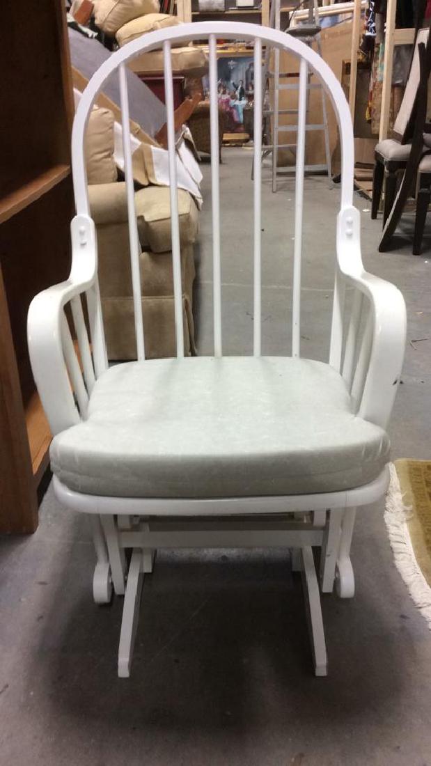 DUTAILIER Wooden Spindle Back Gliding RockingChair: Wooden rocking chair. Contains spindle back. Includes slate green cushion. Tag on bottom reads DUTAILIER. Contains some minor surface scratches. Measures approx 40 inches tall 23 inches wide 31 inches