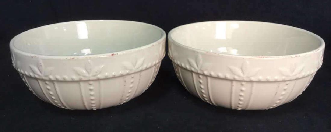SORRENTO Cream Toned Ceramic Bowls: Contains some beaded beveled detail. Both contain some surface wear. Marked SORRENTO on underside. Both have glazed finish. Both bowls have some scratches. Each measures approx 8 inches diameter 3.5 i
