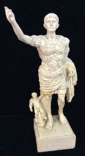 Augustus of Prima Porta Reproduction Figurine: Augustus of Prima Porta Reproduction Figurine. Marble, marble type material, figurine with composite base. Marked as part of the De Giorgio Collection. Figurine of Augustus of Prima Porta with cupid.