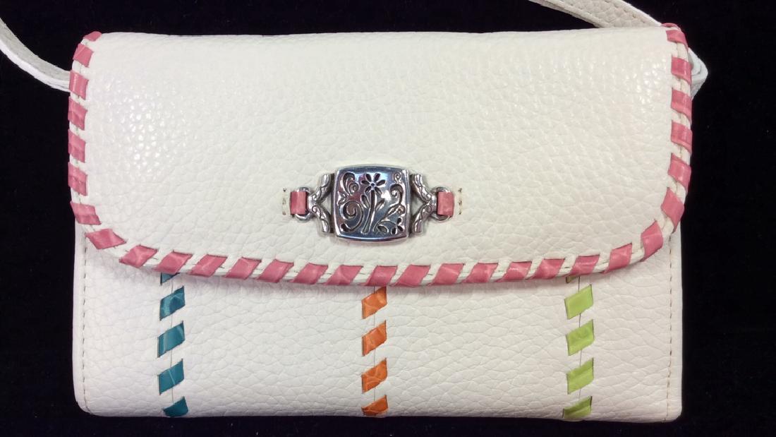 BRIGHTON Folding Women’s Wallet W Strap: BRIGHTON Folding Women’s Wallet W Strap. Adjustable and detachable strap, leather crossbody wallet. White toned leather with silver toned metal floral design details, and multicolored rawhide detail