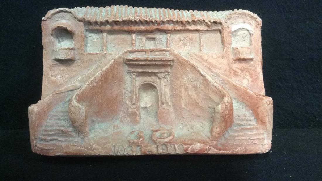 Pink Toned Plaster Architectural Carving: Pink Toned Plaster Carving. Depicts what appears to be European architecture. Contains some chips & cracks. Measures approx 7 inches long 5 inches tall.