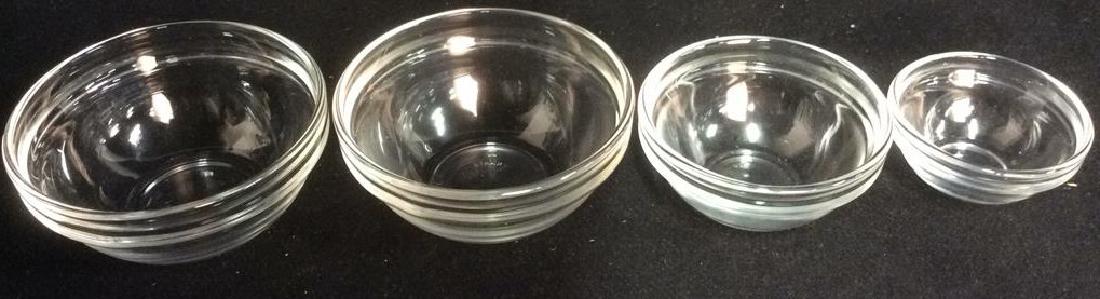 Lot 4 ARC FRANCE Glass Condiment Dishes: Largest dish measures approx 3.5 inches wide 1.5 inches tall. Marked ARC FRANCE on second smallest dish, remaining 3 marked FRANCE. Dishes are glass. Nesting bowls, table top accessories