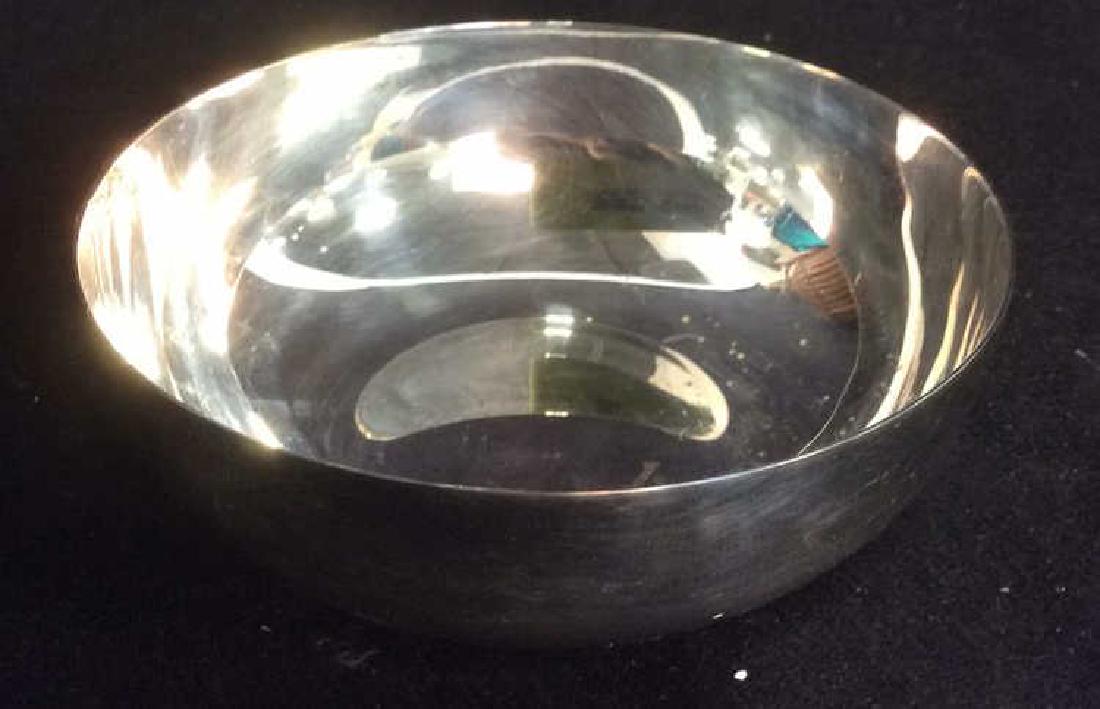 CHRISTOFLE Silver Toned Bowl: CHRISTOFLE Silver Toned Bowl. Appears to have broken handle. Marked CHRSTOFLE on inside. Measures approx 4.5 inches diameter 1.5 inches tall. Contains some surface scratches. Luxury Table top servewar