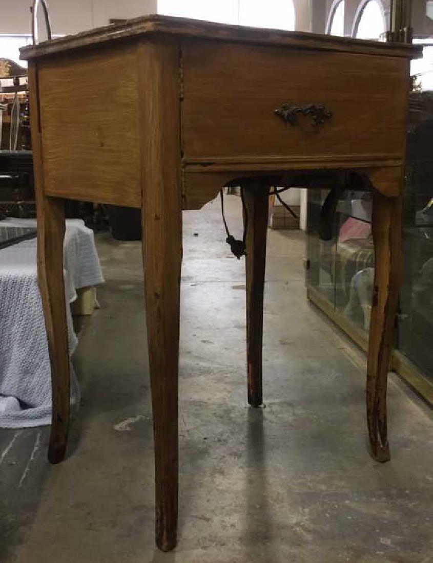 UNIVERSAL Sewing Machine Table with Machine: Marked UNIVERSAL on machine. Contains opening on top of table to view machine. Contains door with handle on front of piece. Measures approx 31 inches tall 22 inches wide 17 inches deep. Sewing table, 