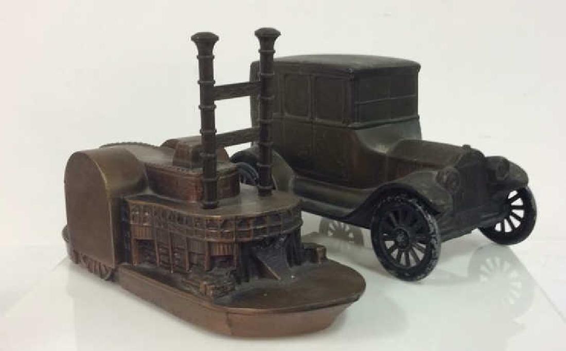 Pair Vintage Metal Coin Banks: Pair Vintage Metal Cain Banks. Car and steam boat statuette metal coin banks. Some Surface wear and chips in paint. measures approx 3 in tall by 6 in wide by 3 in long. Collectible vintage banks