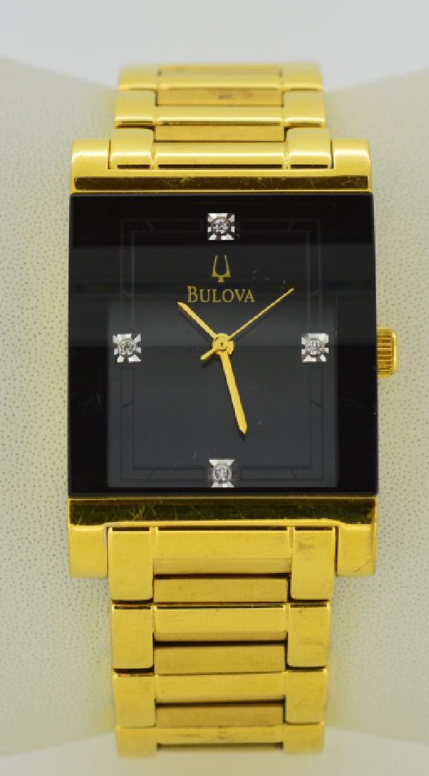Ladies Bulova Gold Plated Wristwatch: Water resistant, gold plated stainless steel wristwatch with black face & deployment clasp