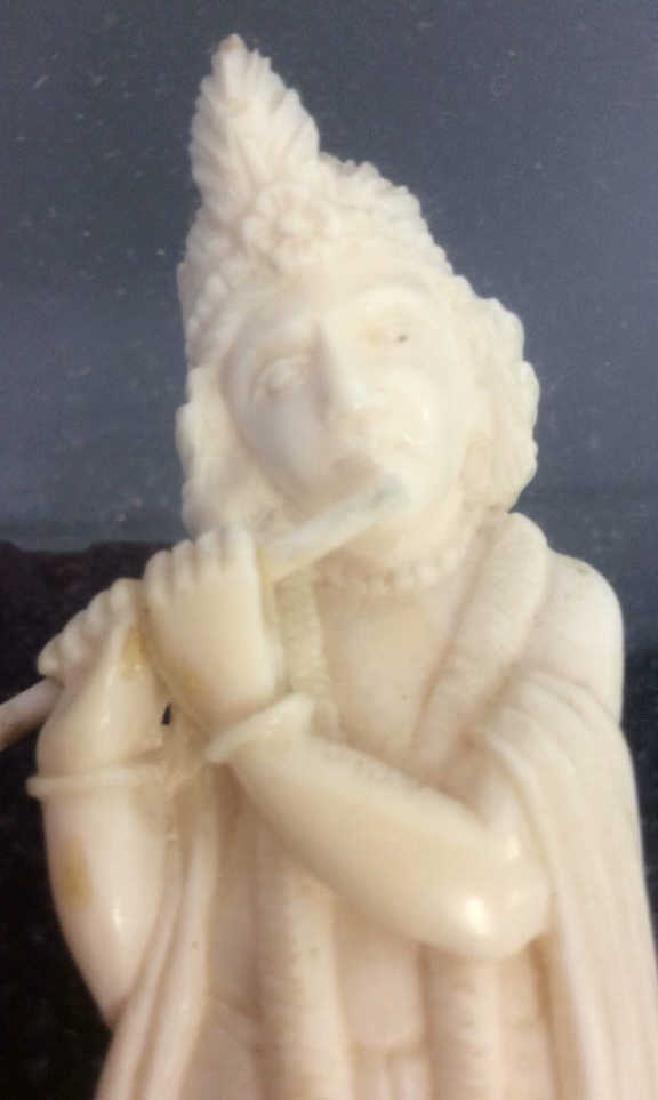 Framed Snake Charmer Figurine Shadow Box: Framed Snake Charmer Figurine. Possibly vintage or antique, framed off white toned carved figurine of a flute playing man standing on a snake. Figurine appears to be carved bone, possibly faux bone co