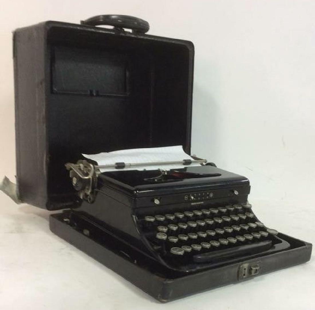 Vintage Black Toned Typewriter In Case: Vintage possibly antique Typewriter is black toned. Appears to have all buttons. Does not include ink. Case has handle. Case is black toned. Case and typewriter has wear consistent with age. Measures 
