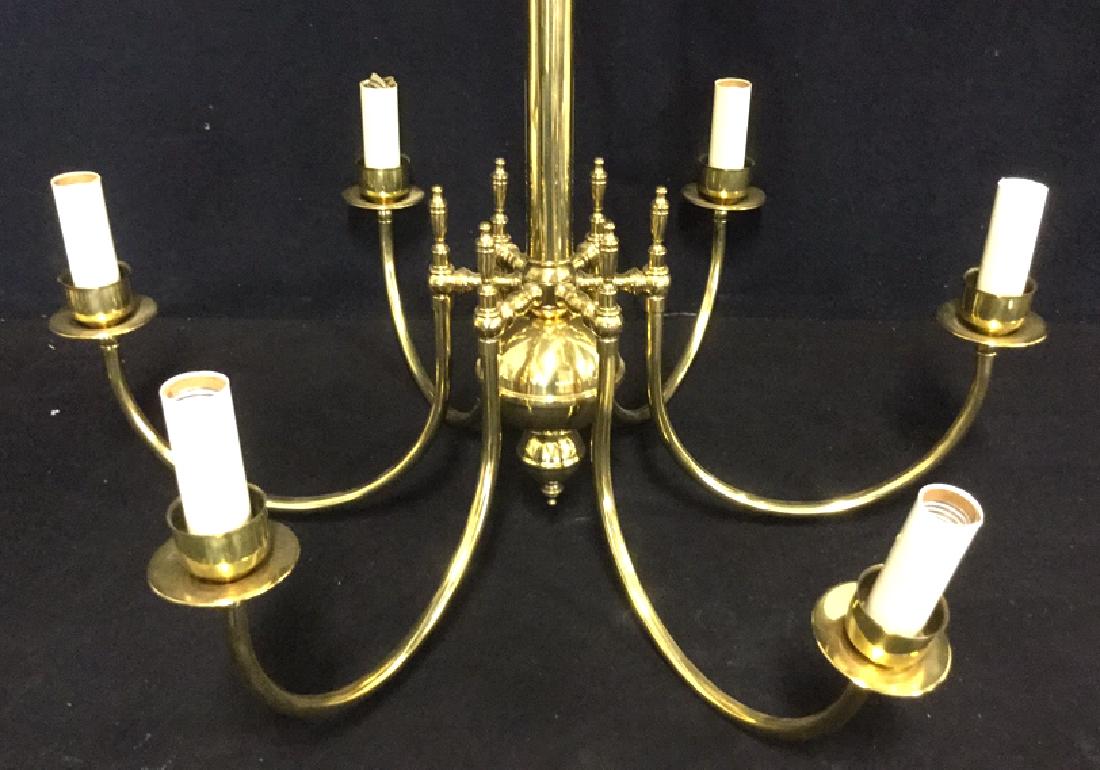 Brass Toned Metal Six Armed Chandelier: Brass Toned Metal Six Armed Chandelier with simple bobeches and cups that hold faux candles extending from a long center column. Home lighting. Home Decor. Decorative Lighting. Needs polishing. Measur