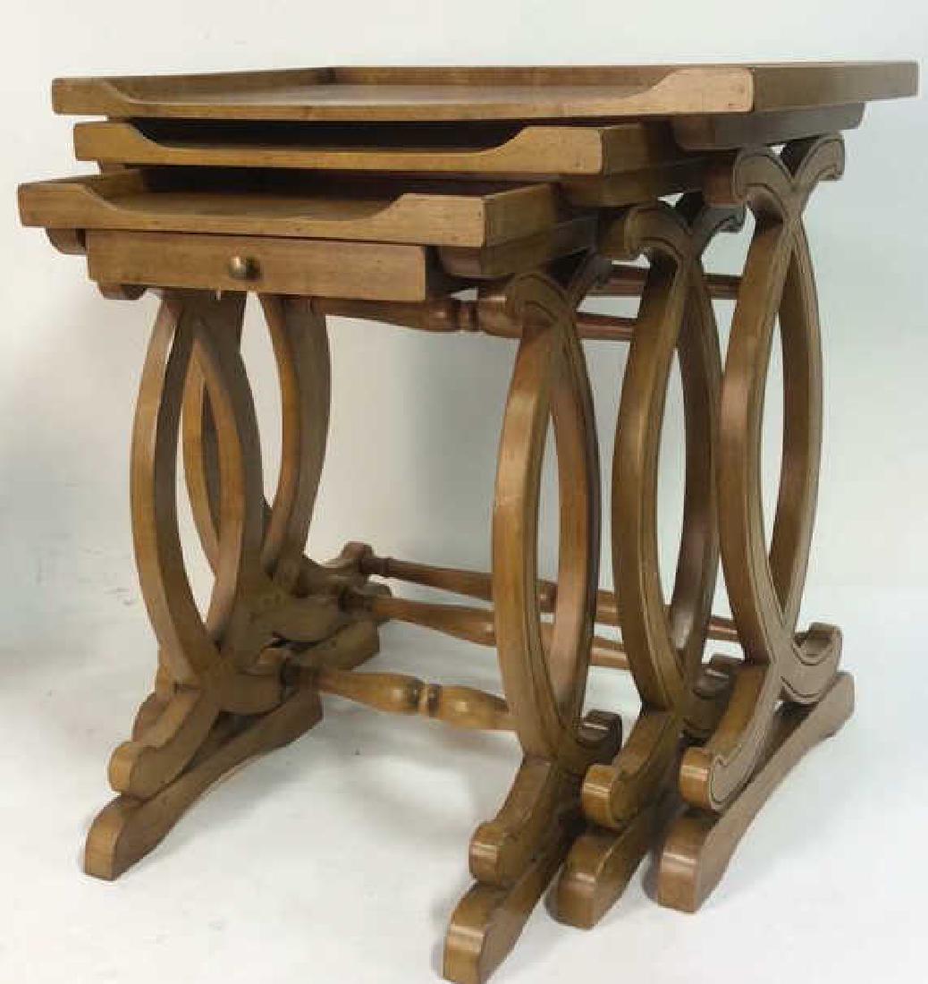 Lot 3 Carved Wooden Nesting Tables: Possibly vintage. Includes 3 wooden nesting tables. Each contain carved wooden detail. Smallest table has drawer with gold toned knob style handle. Largest table measures approx 25 inches tall 25 inch