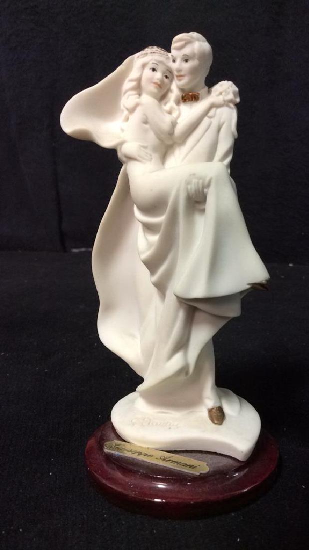 Vintage GIUSEPPE ARMANI Bride & Groom Figural: Marked GIUSEPPE ARMANI on base. Depicts a groom carrying his bride. Marked 1992 FLORENCE on backside. Measures approx 5 inches tall 2.5 inches wide. Has minor chips at brides foot.