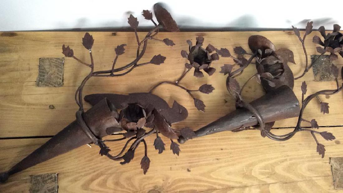 Pair Bird And Floral Decorative Wall Hangings: Pair Bird And Floral Decorative Wall Hangings with candleholders and conical vases. Bird figural with floral branch design. Weathered metal. Some stains on metal. Measures approx 18min tall by 11 in w