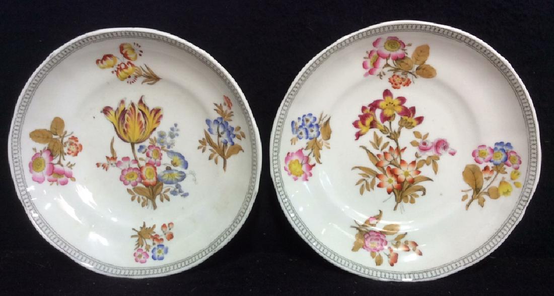 Lot 2 MINTON Floral Detailed Porcelain Plates: Both marked MINTON on underside. Each have multitoned floral detail. Both have patterns detail around edges. Each measures approx 7 inches diameter.