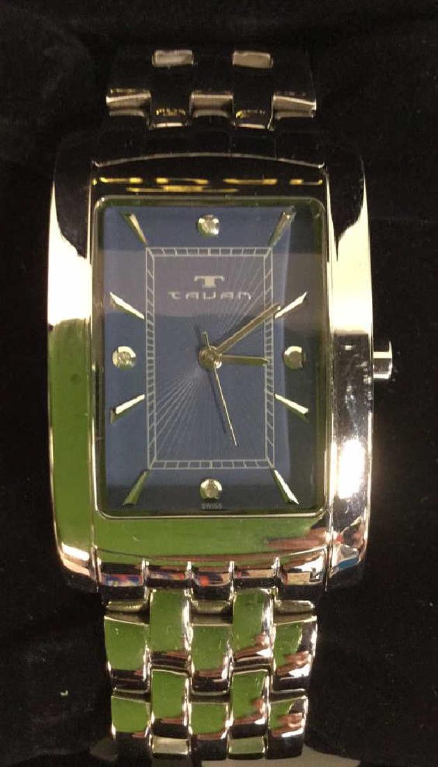 TAVAN Silver Toned Watch In Original Box: Inside box is marked TAVAN. Watch is silver toned and has blue toned clock face with a Silver toned TAVAN Marking. Measures approx 6.5 inches around. Wristwatch, luxury watch, fashion watch, men's wat