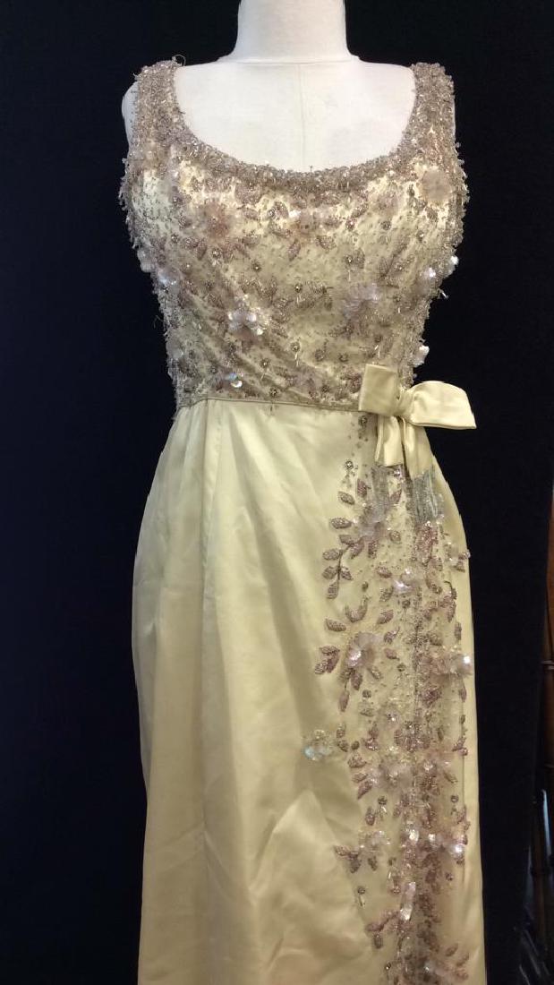 Beaded & Sequined Ladies Couture Dress: Beaded & Sequined Ladies Dress. Ladies fashion. Cream toned silk textured fabric strapless dress with floral beading and seashell shaped sequined top and trailing design down side of skirt. Bow detail