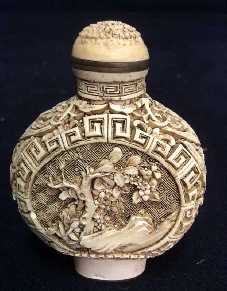 Intricately Carved Bone Asian Snuff Bottle: Vintage possibly antique Asian snuff bottle; intricately carved detail of garden scenes, signed etched underside with asian characters, Asian arts and crafts, asian snuff bottle collectible, orientali