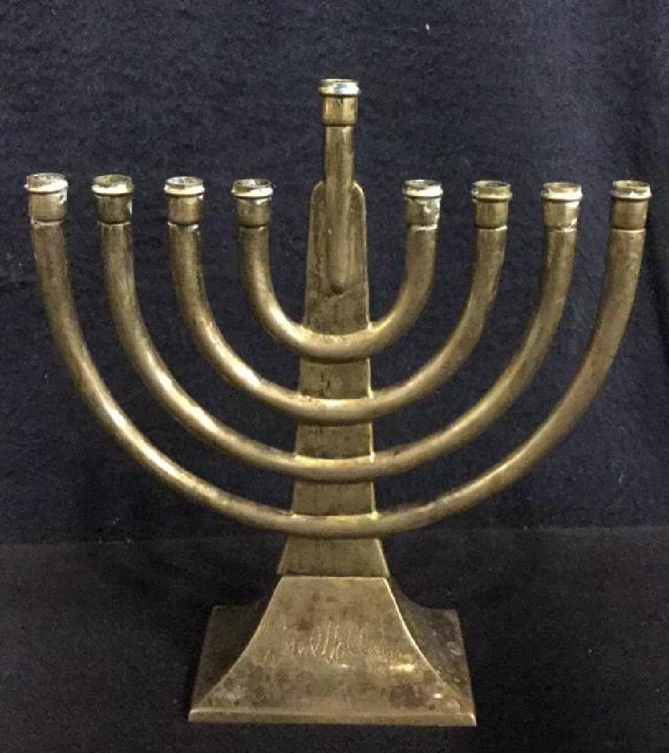 Fred Hollings Brass Toned Metal Menorah: Fred Hollings Brass Toned Metal Menorah. Judaica. Jewish Tabletop accessories. Jewish menorah. Signature Etched on base of menorah by artist. Some tarnishing to metal. Measures approx 7 inches tall x 