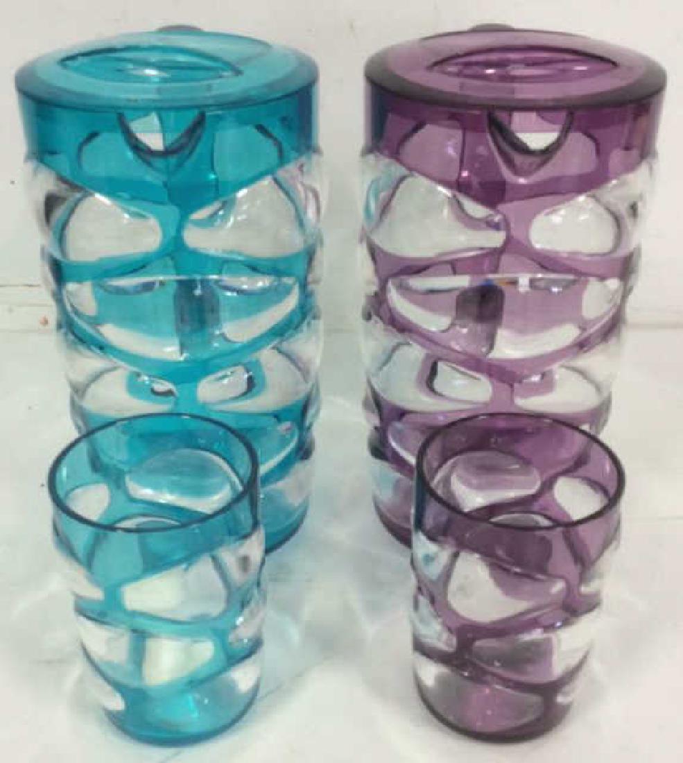 Lot 4 Matching Mod Style Pitchers & Cups: Includes 2 pitchers and 2 cups. One set is aqua toned while the other is purple toned. Pitchers measure approx 9 inches tall 7.5 inches wide with handle.. a Contains clear, beveled geometric detail.