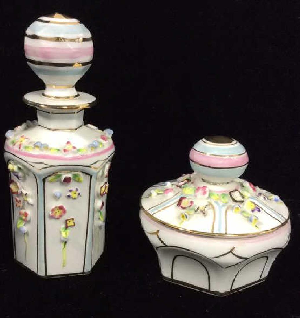 Lot 2 IRICE Hand Painted Perfume Bottle W Dish: Lot 2 IRICE Hand Painted Perfume Bottle W Lidded Trinket Dish. Hand painted white toned porcelain with painted gold, blue and pink toned designs with painted and three dimensional flowers on sides of