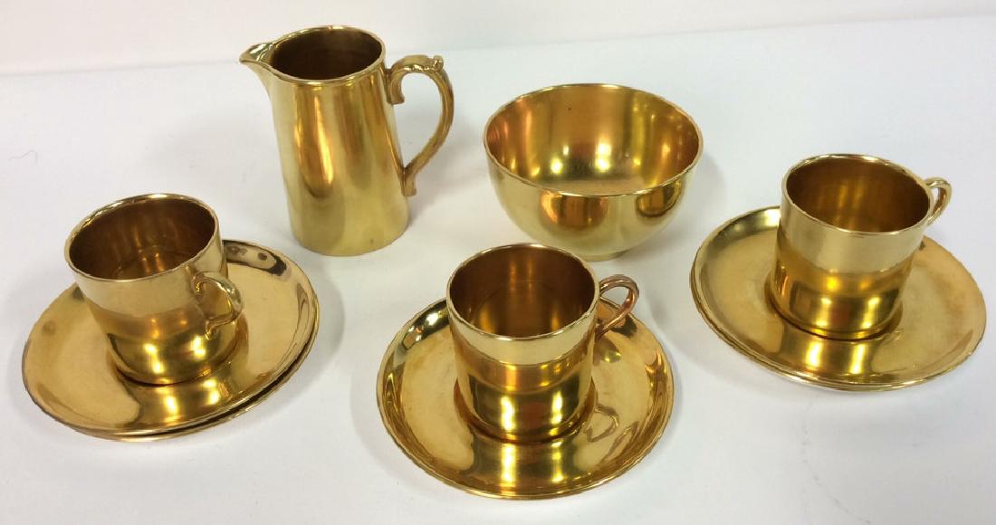 Set 10 Gold Toned Aynsley Bone China Tea Set: Set 10 Gold Toned Aynsley Bone China Tea Set marked on underside Aynsley England Bone. Set includes creamer, sugar bowl, 3 cups and 5 saucers. Some minor surface scratches. Pitcher measures approx 3.5