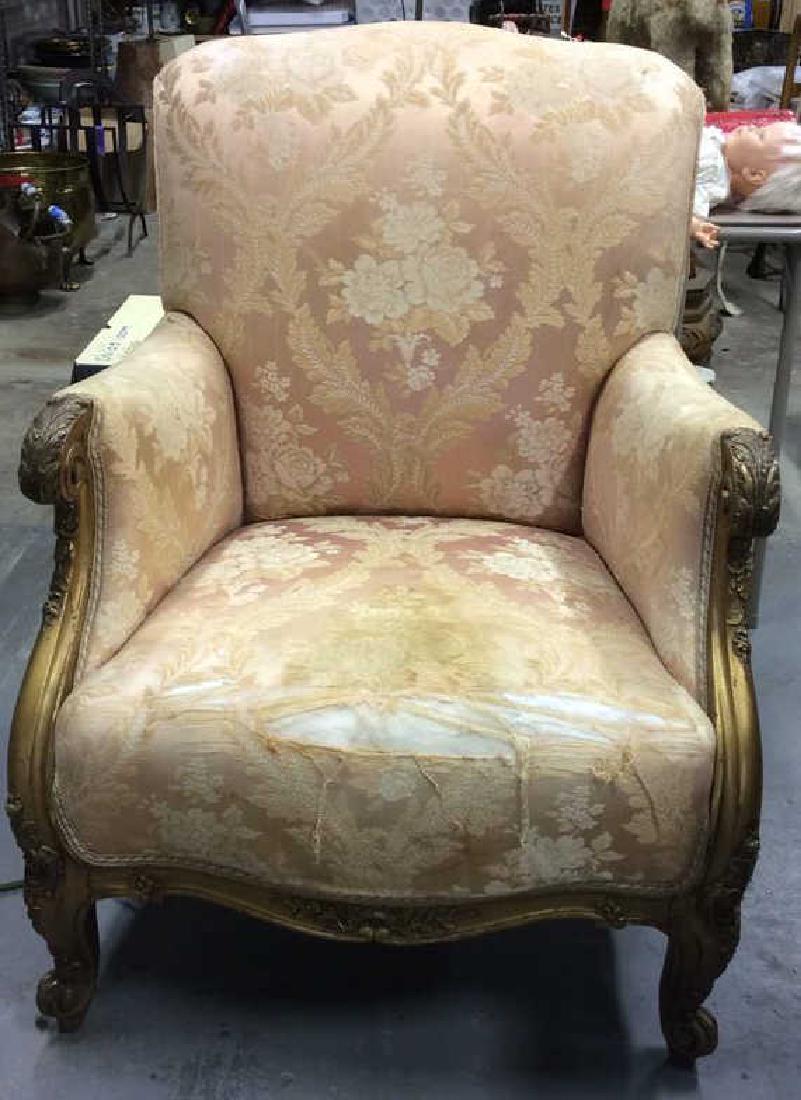 Vintage Floral Detailed Upholstered Gold Armchair: Chair is Vintage possibly antique. Chair contains intricate floral detail. Chair has ornate gold toned wooden detail at armrests & legs. Chair legs have c curve style feet. Measures approx 38 inches t