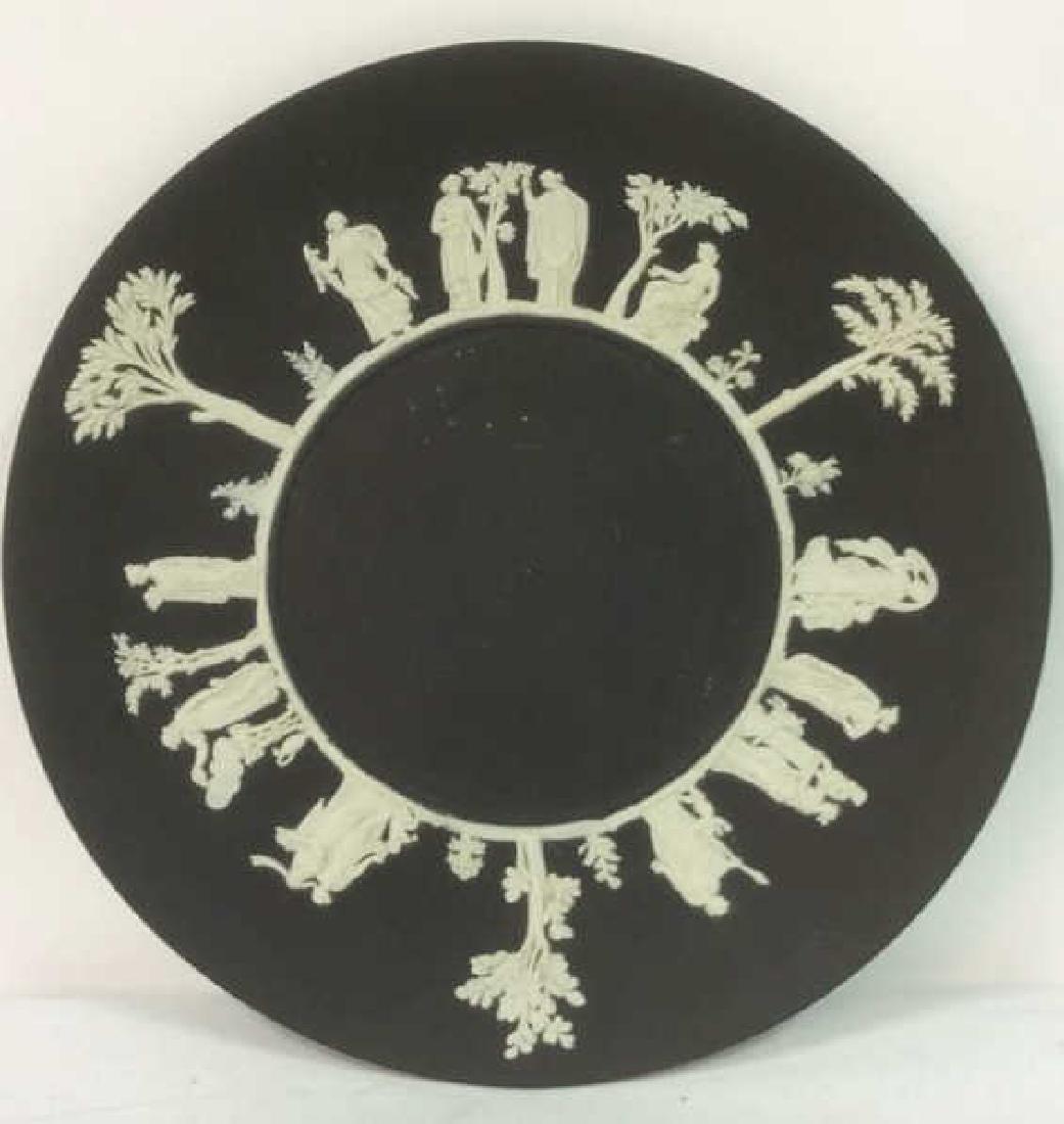 Black Toned Wedgwood Plate: Piece is marked WEDGWOOD on underside. Piece contains intricate white toned detail. Piece condition minor imperfections. Measures approx 9 inches diameter.