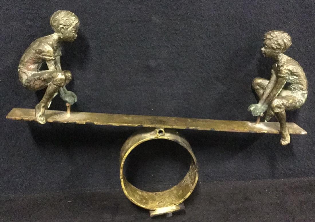 Cast Metal Sculpture Of Two Boys On A Seesaw (1 of 8)
