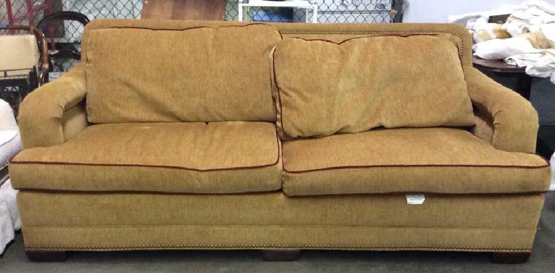 STANFORD FURNITURE CO. beige tone couch Sofa: STANFORD FURNITURE CO. beige tone couch, gold beaded detail, nail head trim around border, red tone lining, good condition approx 91 long, 37 tall, 44 inch deep. contains wooden feet. Property of Fair