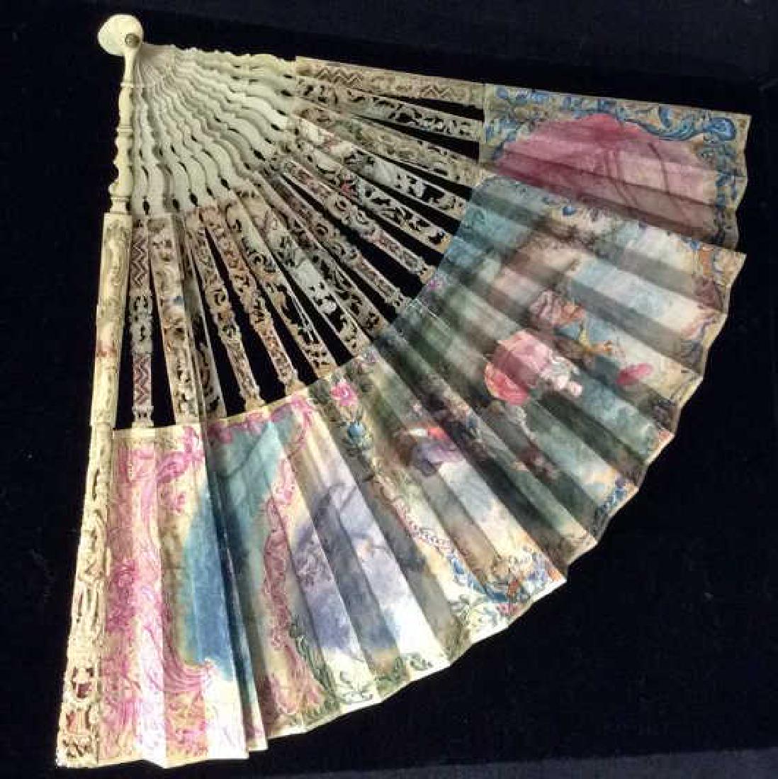 Poss Antique Ladies Fan W Painted Scene: Poss Antique Ladies Fan W Painted Scene. Possibly vintage or antique, women’s fan with carved openwork bone, possibly faux bone, body with intricate filigree and standing man design, parchment fan w