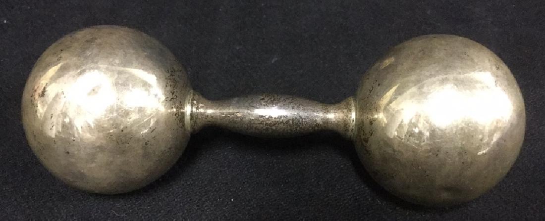 Tiffany & Co Sterling Silver Baby Rattle: Tiffany & Co Sterling Silver Baby Rattle. Sterling silver baby gift. Baby Toys. Sterling silver baby rattle with a circular ball on each end. Marked on handle reads, Tiffany & Co 925. Small dents and 