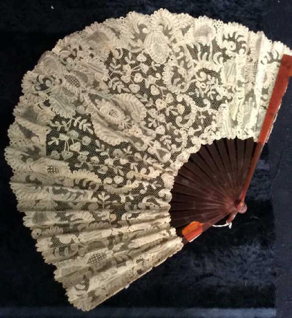 Antique Carved Shell And Lace Ladies Fan: Antique Carved Shell And Lace Ladies Fan. faux shell body, possibly bakelite or celluloid. panels support antique lace with floral and leaf motif. Some minor wear. Measures approx 23 inches wide x 18 